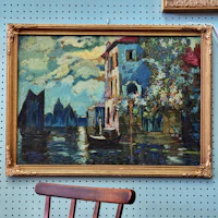 a painting on a wall next to a chair