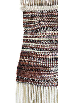 a brown and white woven wall hanging
